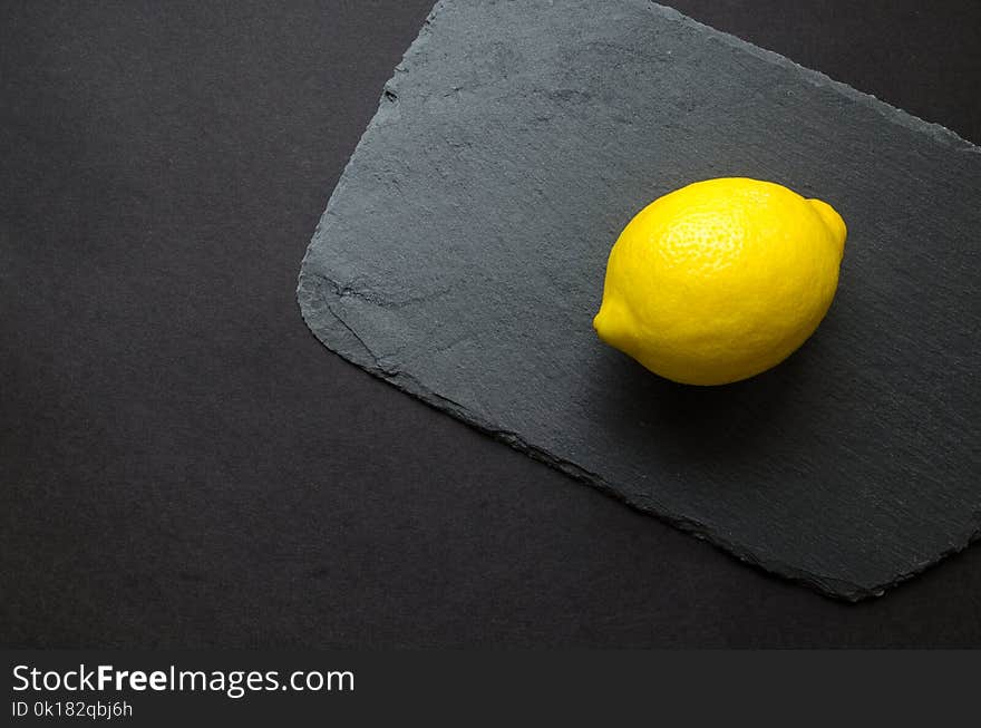 Photo of Yellow Lemon on Gray Surface