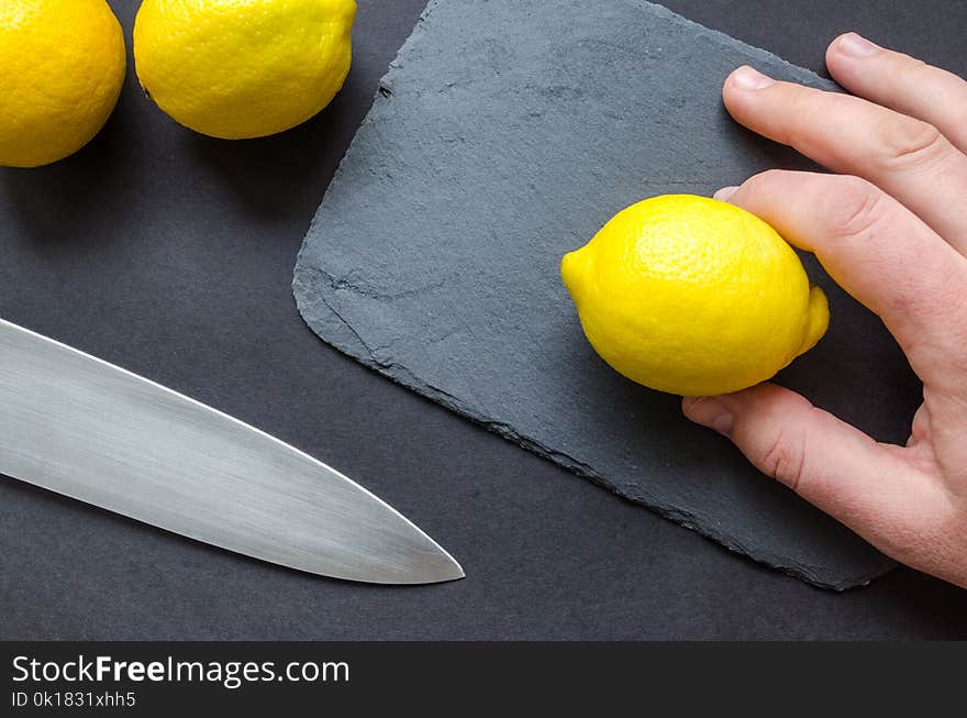 Person Holding A Lemon