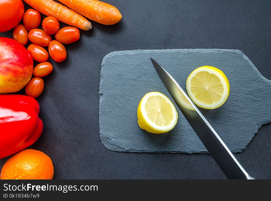 Sliced Lemon on Gray Chopping Board