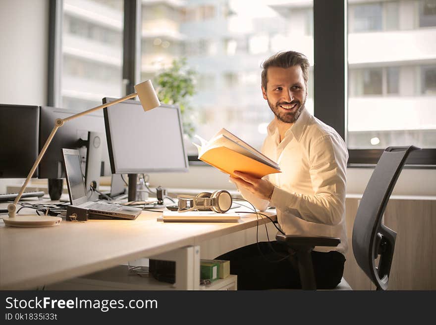 Photo of Man Holding a Book