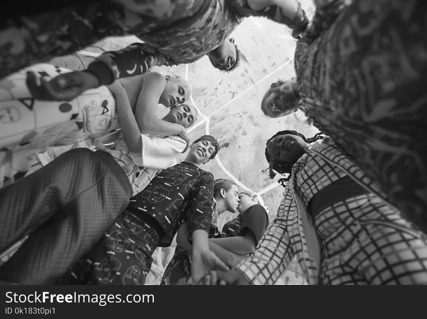 Grayscale Photo of People Together Inside Room