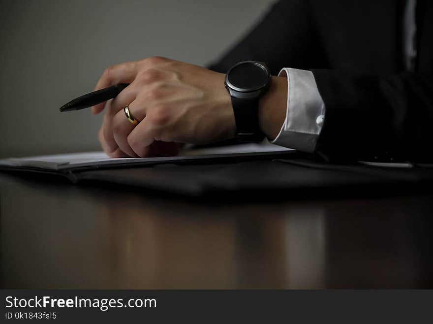 Person Holding Black Pen