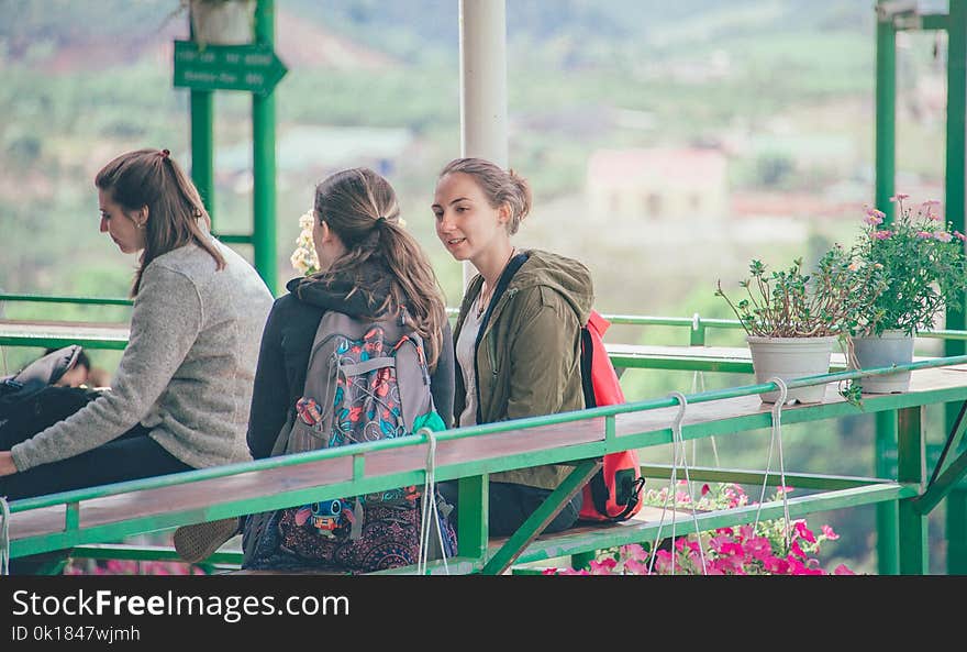 Photo of Women Sitting on Bench