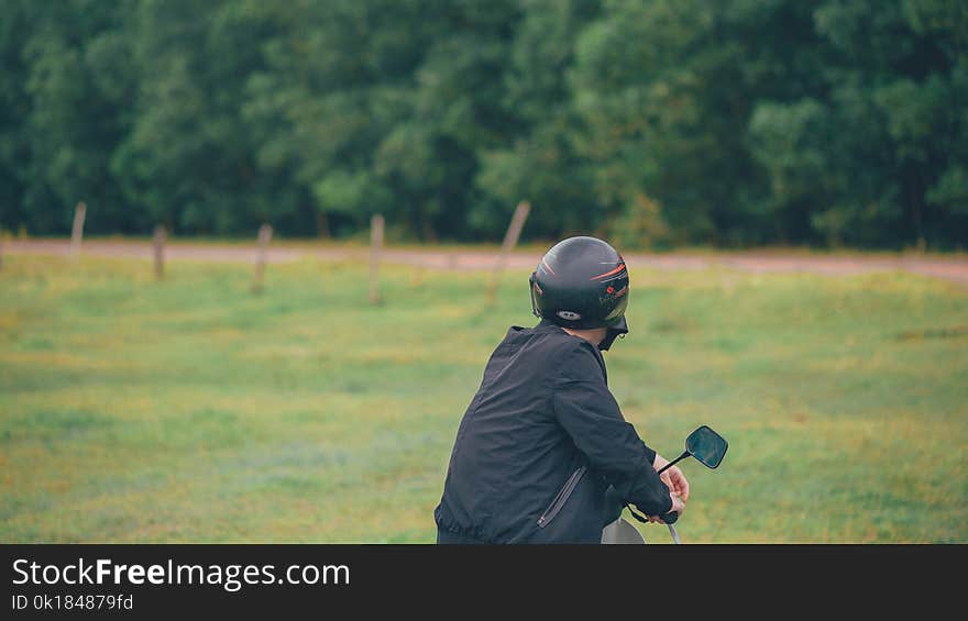 Photo of a Man Wearing Black Helmet