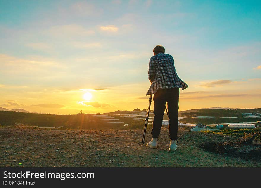 Photo of a Person Taking Photograph of Sun