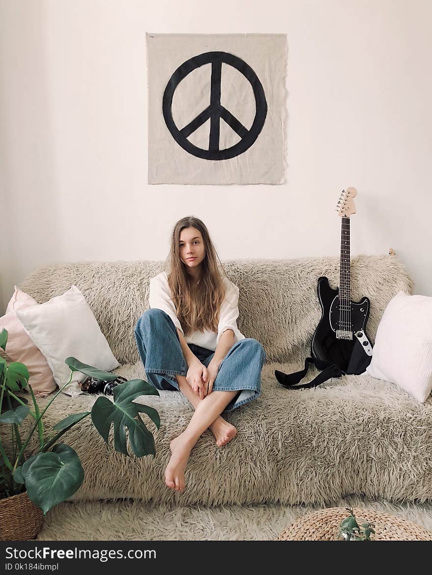 Woman Sitting in Grey Fur Sofa