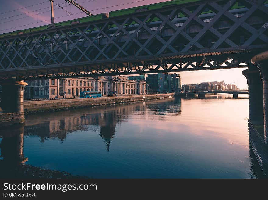 Gray Metal Bridge Near Brown Concrete Building