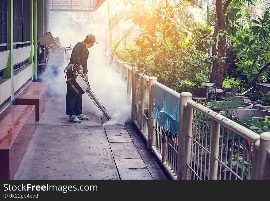 Man Work Fogging To Eliminate Mosquito For Preventing Spread Dengue Fever And Zika Virus