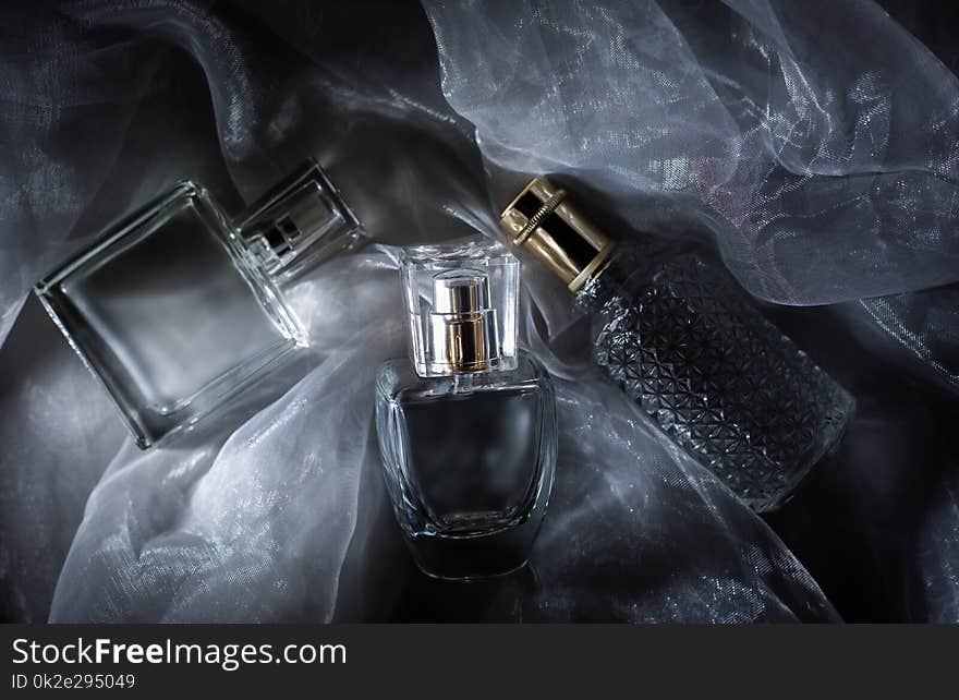 Three Perfume Bottle On Gray Background