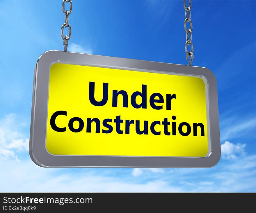 Under Construction on yellow light box billboard on blue sky background. Under Construction on yellow light box billboard on blue sky background