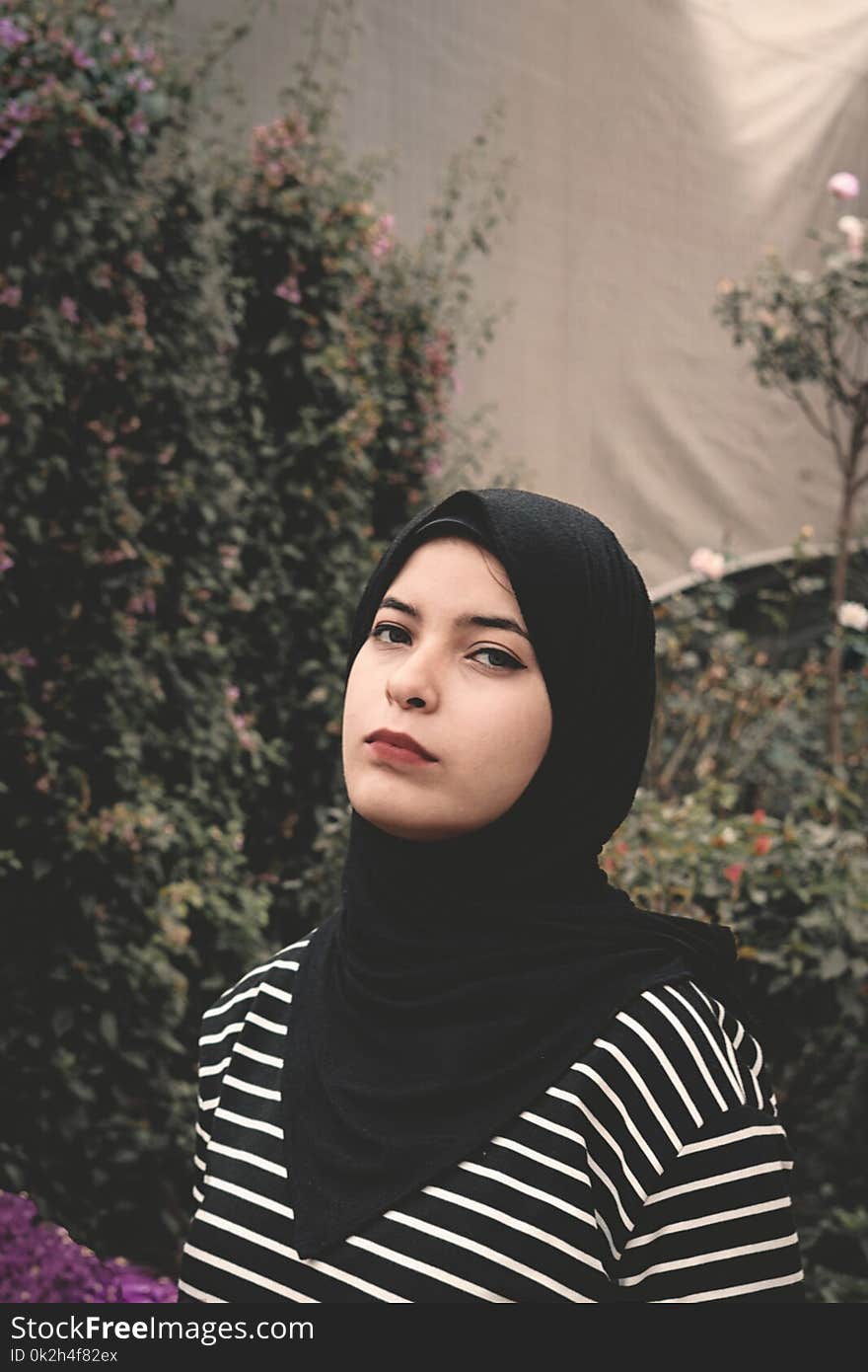 Woman Wearing Black and White Striped Top and Black Veil