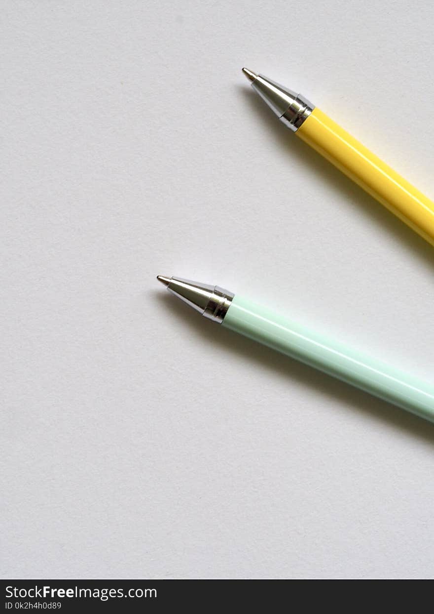 Photo of Teal and Yellow Point Pens