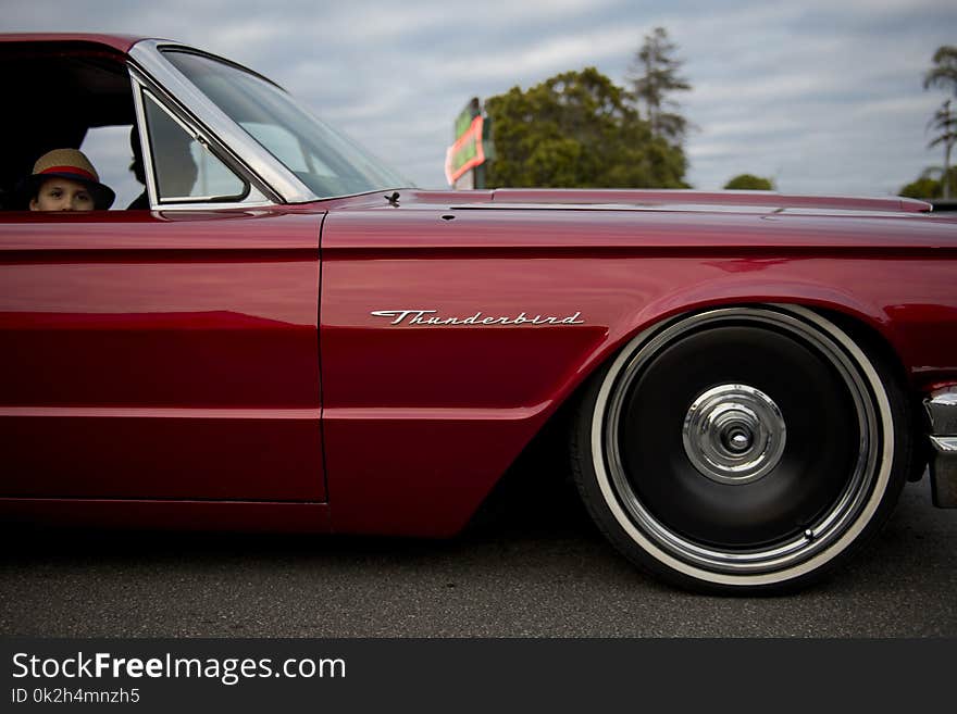 People Inside Red Thunderbird Car