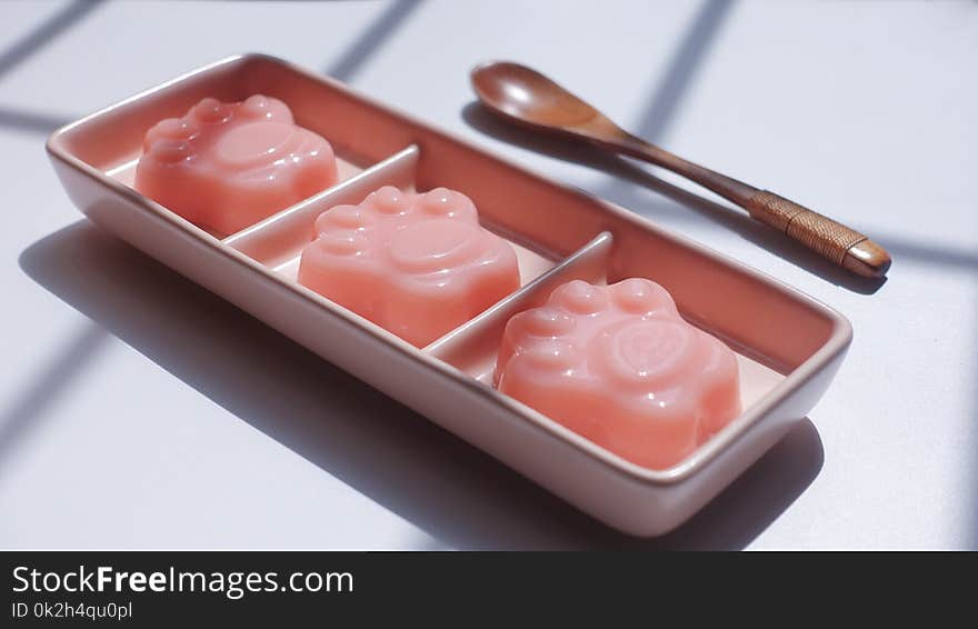 Paw Shape Jell-o on Pink Ceramic Container Near Brown Wooden Tablespoon