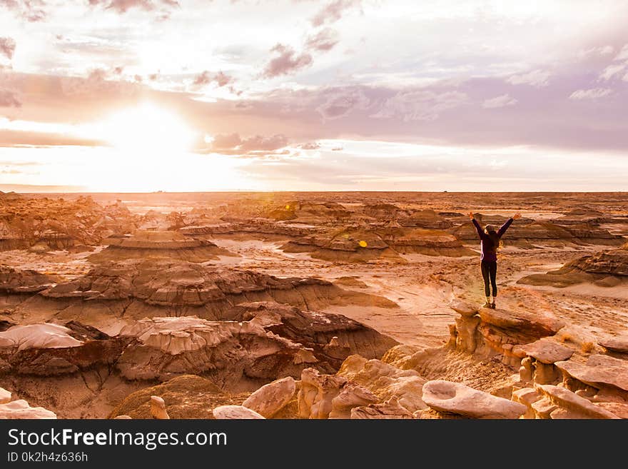 Woman Stands on Brown Surface at Daytime