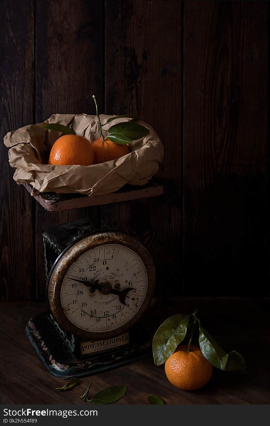 Three Orange Fruits and Analog Scale