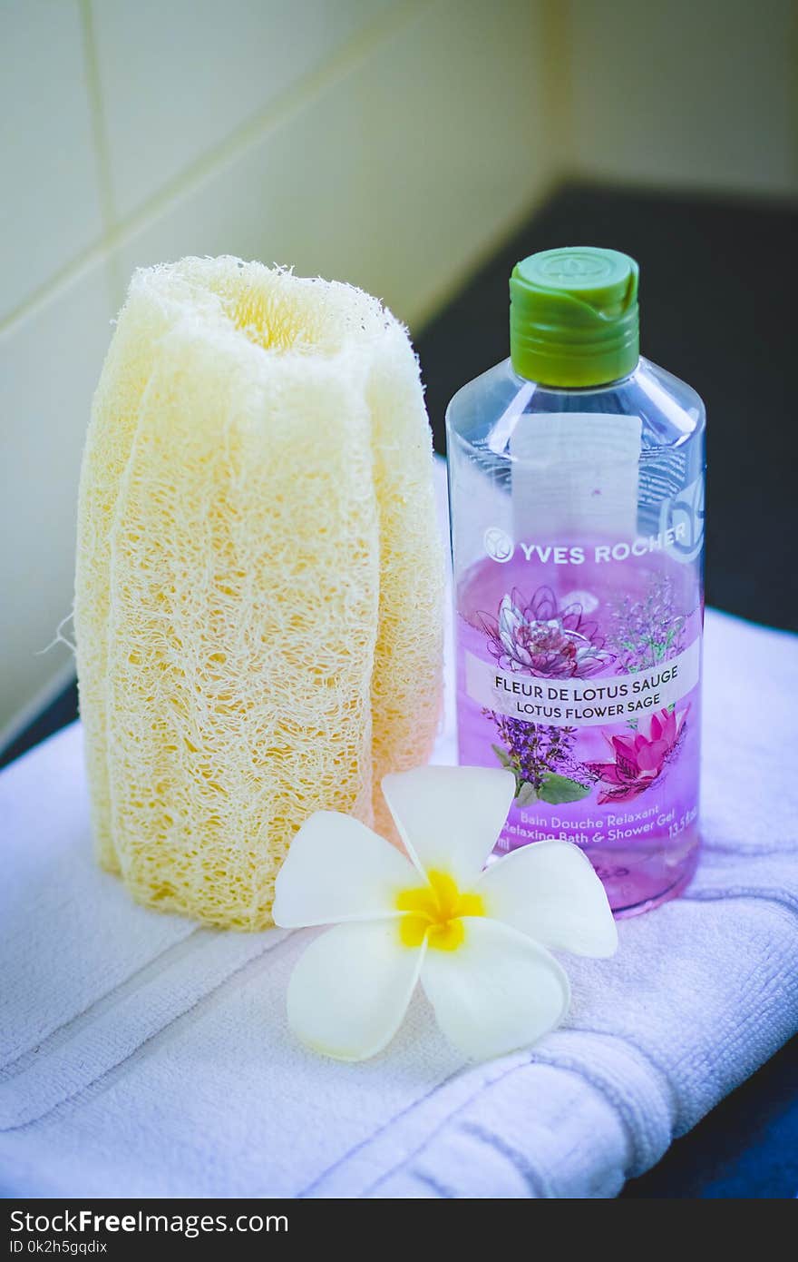 Shallow Focus Photography of Yves Rocher Bubble Bath Bottle on White Towel