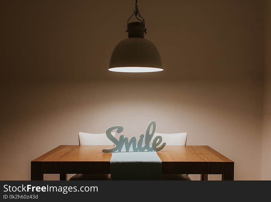 White Smile Cutout Signage on Table