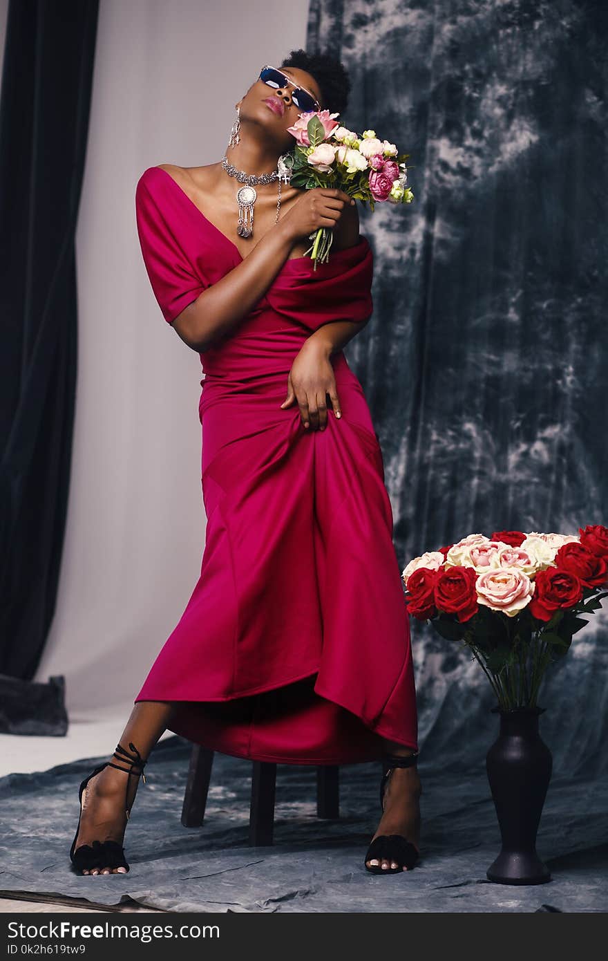 Woman in Red Dress Holding Flower