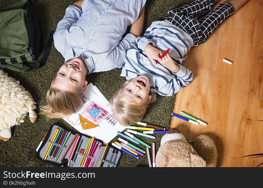 Brothers lying on the floor and draw. Brothers lying on the floor and draw