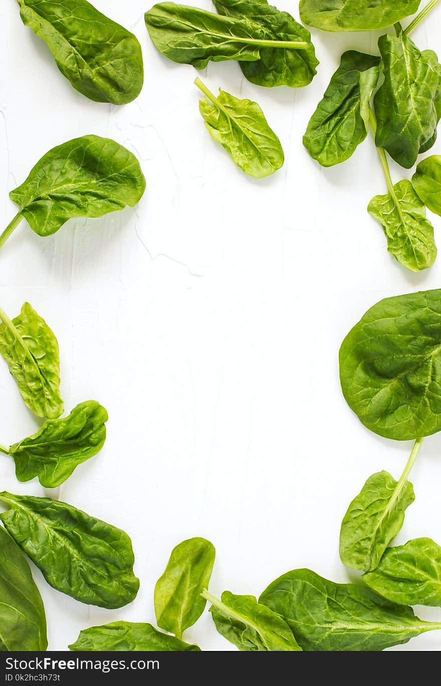 Frame Made Of Spinach Leaves On White Background.