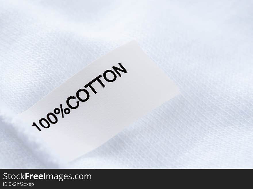 Close up of Cloth tag 100% cotton on white fabric