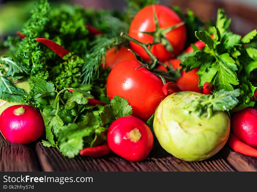 Fresh vegetables and herbs on wooden table