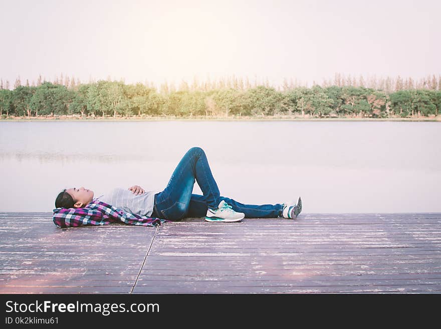 Relaxing moment Asian tourist rest on park ,enjoying time on holiday concept ,color of vintage tone