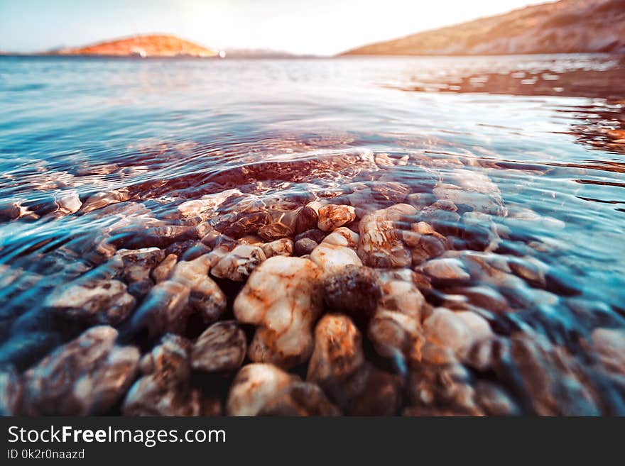 Beauty of underwater nature, the stony bottom is seen through the clear water of the Mediterranean Sea, summer holidays in Greece