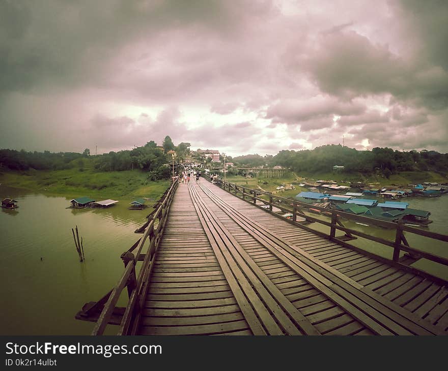 Mon bridge or “Saphan Mon” or `Uttama Nusorn Bridge` is Thailand’s longest wooden bridge and the second longest in the world measuring over 400 meters long.It is the landmark of Sangkhlaburi district.The handmade footbridge constructed in the 1980’s spans the Songalia river to the Mon village Wang Kha.Late July 2013 part of the bridge collapsed after heavy rainfall. The pressure caused by a buildup of weeds brought there by strong currents made of section of the bridge come down. The bridge has been restored since then. Mon bridge or “Saphan Mon” or `Uttama Nusorn Bridge` is Thailand’s longest wooden bridge and the second longest in the world measuring over 400 meters long.It is the landmark of Sangkhlaburi district.The handmade footbridge constructed in the 1980’s spans the Songalia river to the Mon village Wang Kha.Late July 2013 part of the bridge collapsed after heavy rainfall. The pressure caused by a buildup of weeds brought there by strong currents made of section of the bridge come down. The bridge has been restored since then.