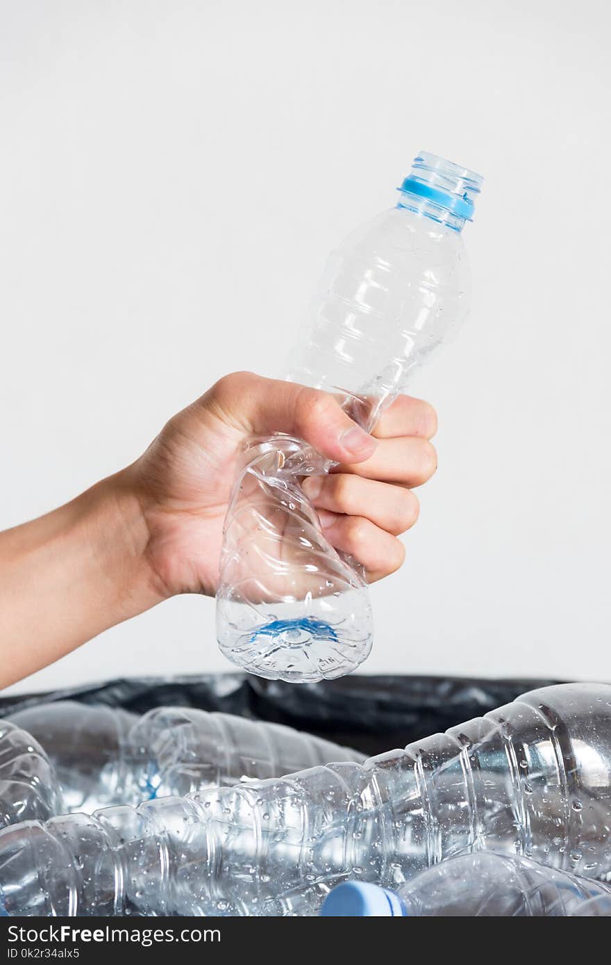 Plastic bottles in black garbage bags waiting to be taken to recycle.