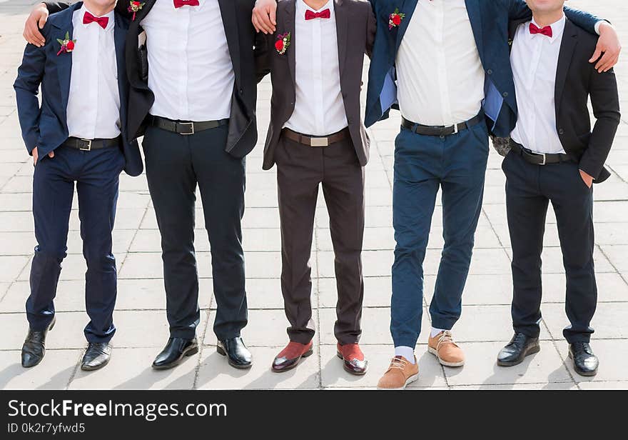 Groom and his friends pose in a restaurant