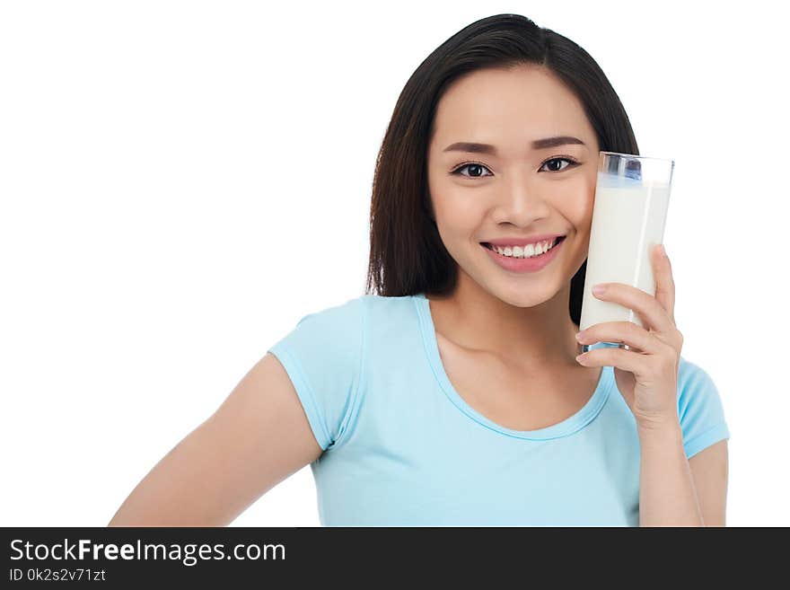 Lovely pretty Asian woman holding glass of milk next to her face. Lovely pretty Asian woman holding glass of milk next to her face