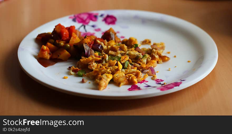 Scrambled egg omelette and mixed vegetable served on a plate. Indian home made dish.side view