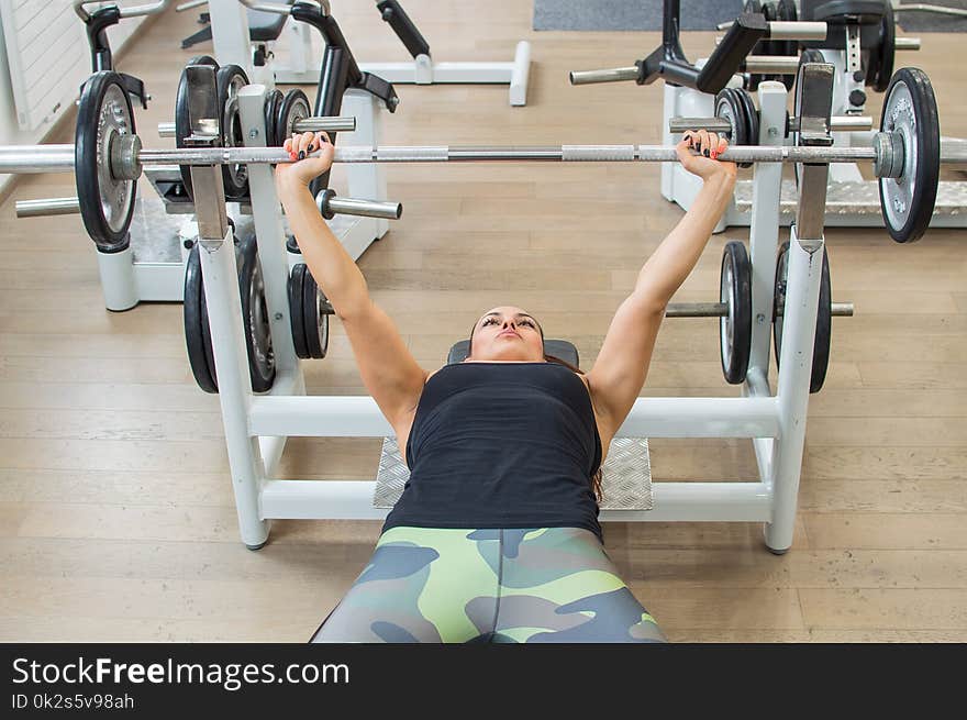 Woman in a gym cuddling with her hands. Woman in a gym cuddling with her hands.