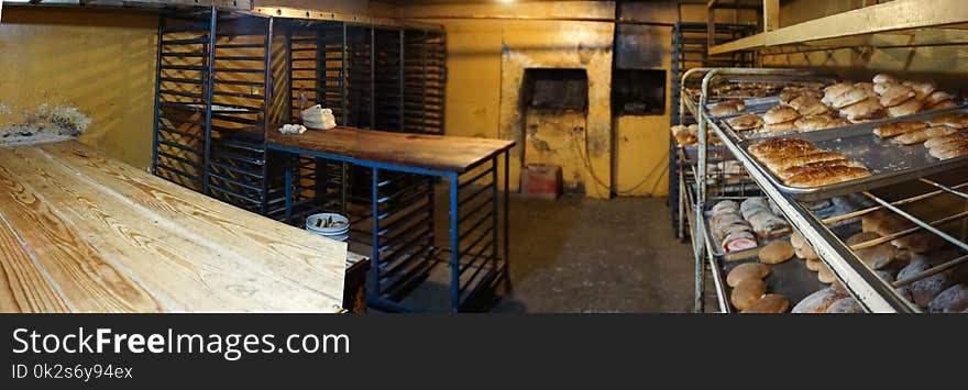 A traditional mexican bakery with his oven in the wall and some pieces of sweet bread stacked in trays ready to be sale. A traditional mexican bakery with his oven in the wall and some pieces of sweet bread stacked in trays ready to be sale