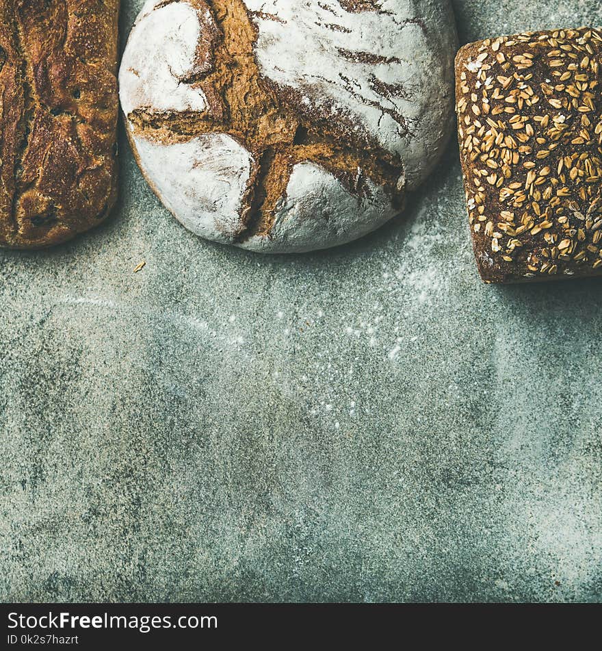 Top view of bread loaves over grey background, square crop