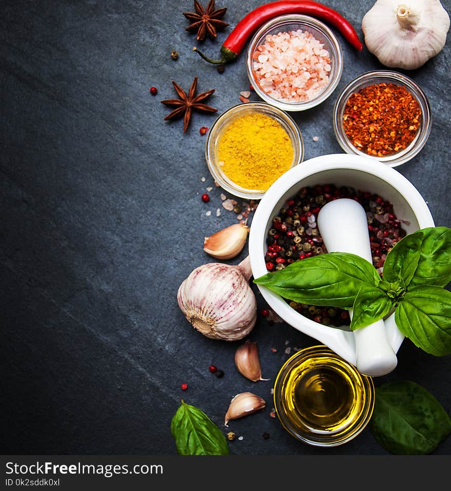 Different kind of spices on black stone background