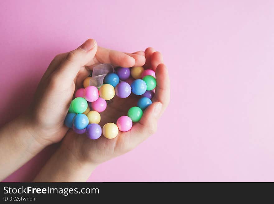 Gently spring multi-colored beads in children`s hands