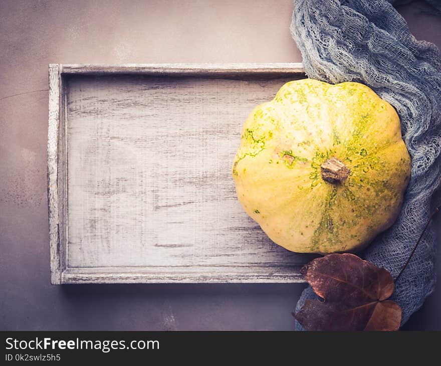 Autumn fall flat lay background with decorative pumpkin on wooden tray. Autumn fall flat lay background with decorative pumpkin on wooden tray