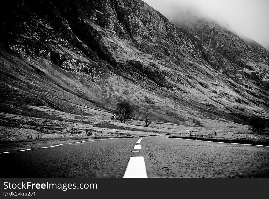 Grayscale Photo of Road Thru Mountain