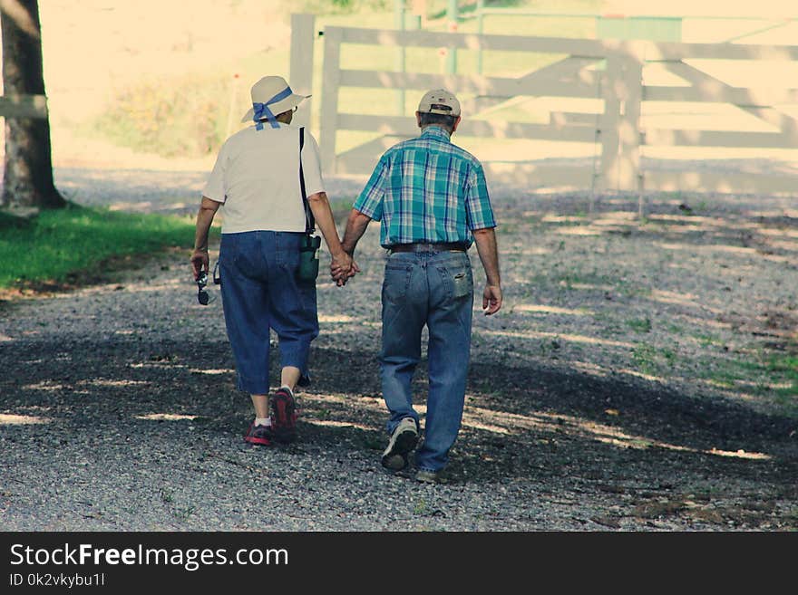 Old Couple Walking While Holding Hands