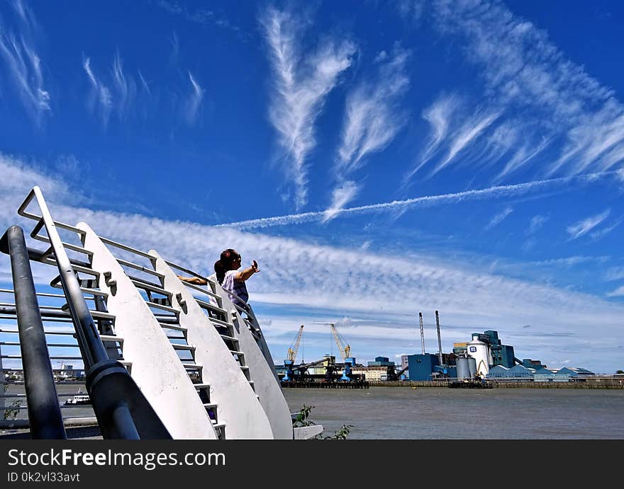 Woman Standing on Front of Gray Barriers