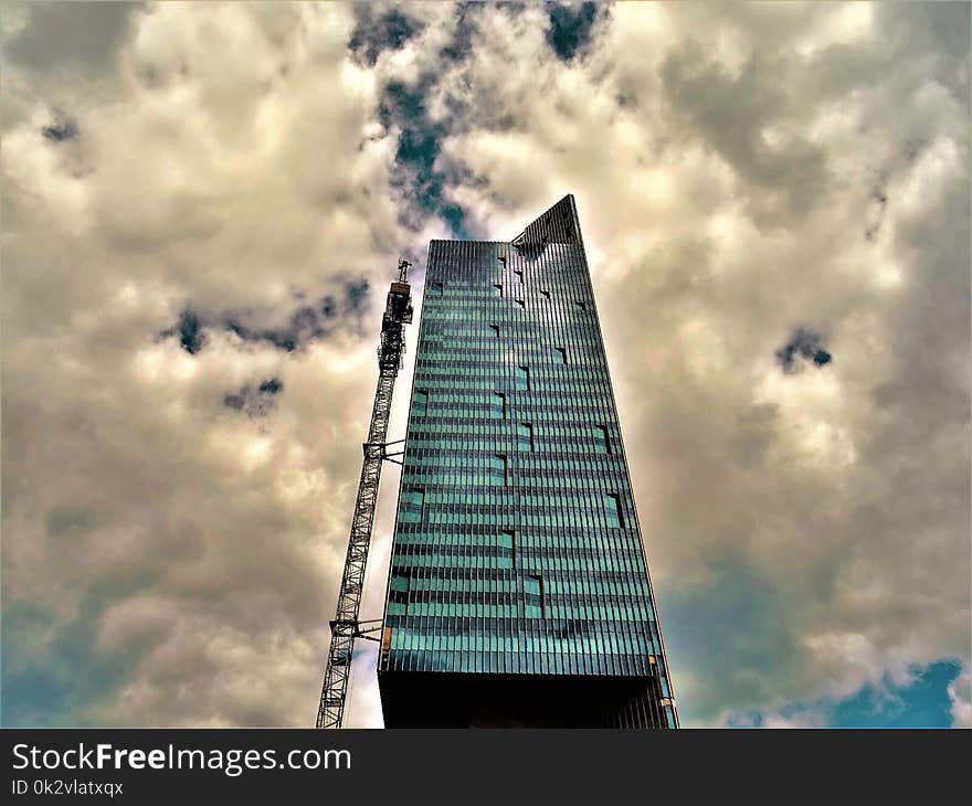 Black High-rise Building With White Clouds