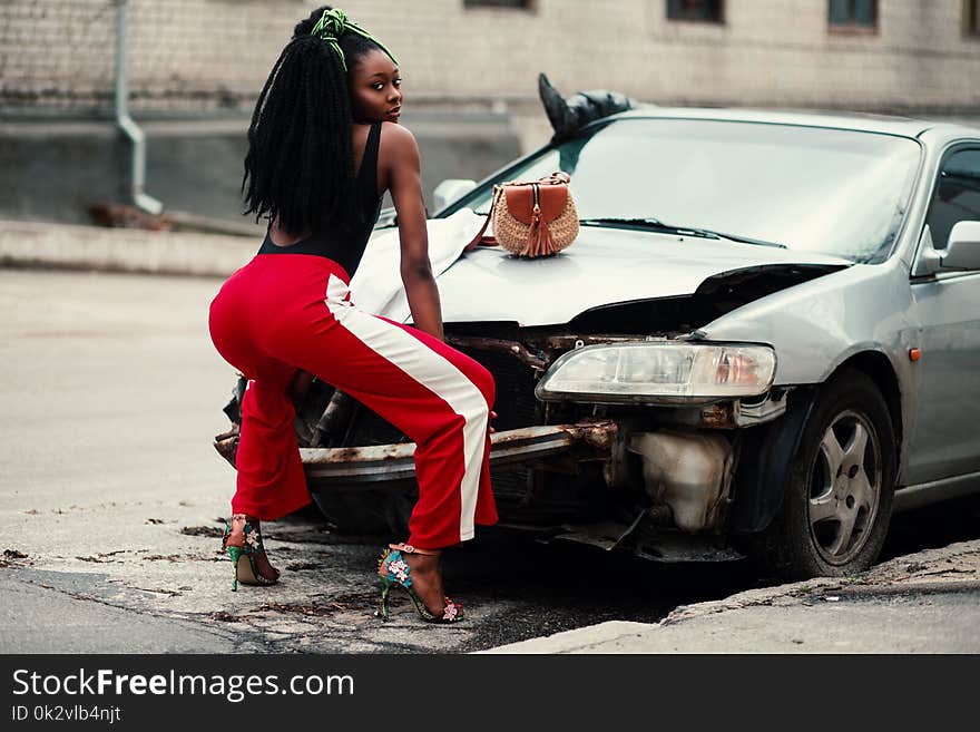 Photograph of Woman About to Twerk in Front of Vehicle