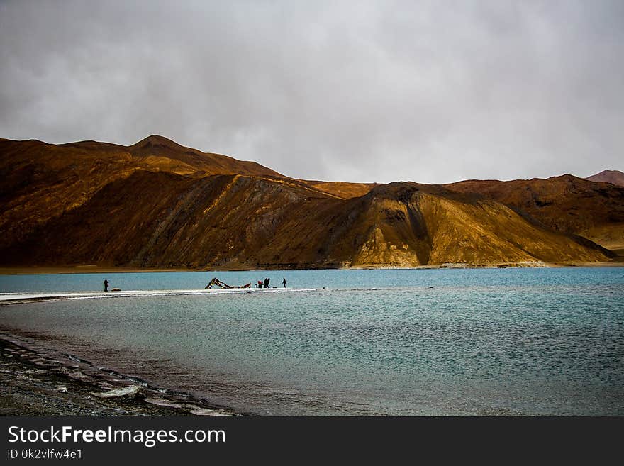 Body of Water With Mountain Ahead