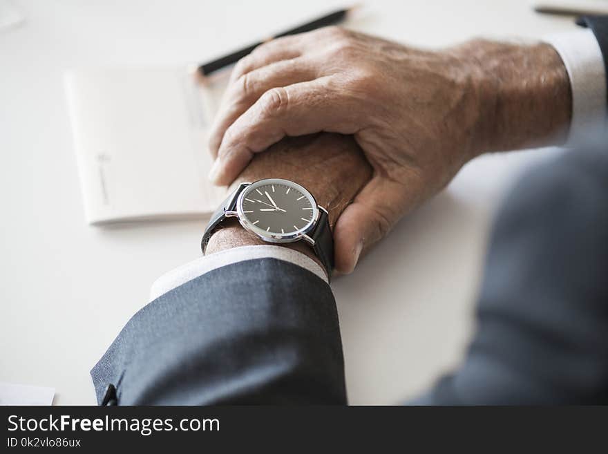 Person Wearing Round Analog Watch With Black Strap