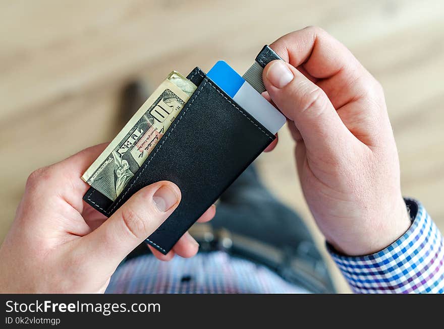 Person Holding Black Card Holder