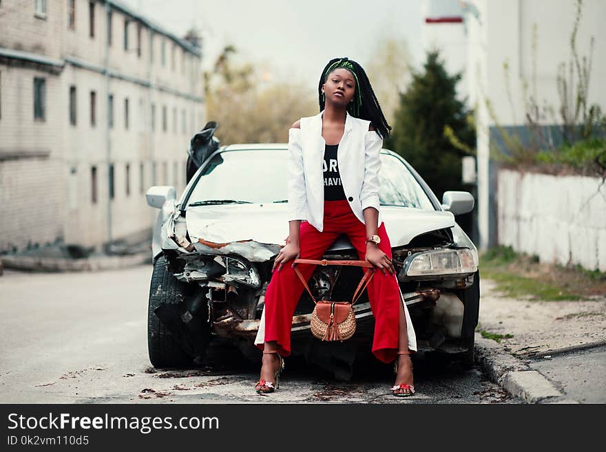 Woman Sitting in Front of the Car