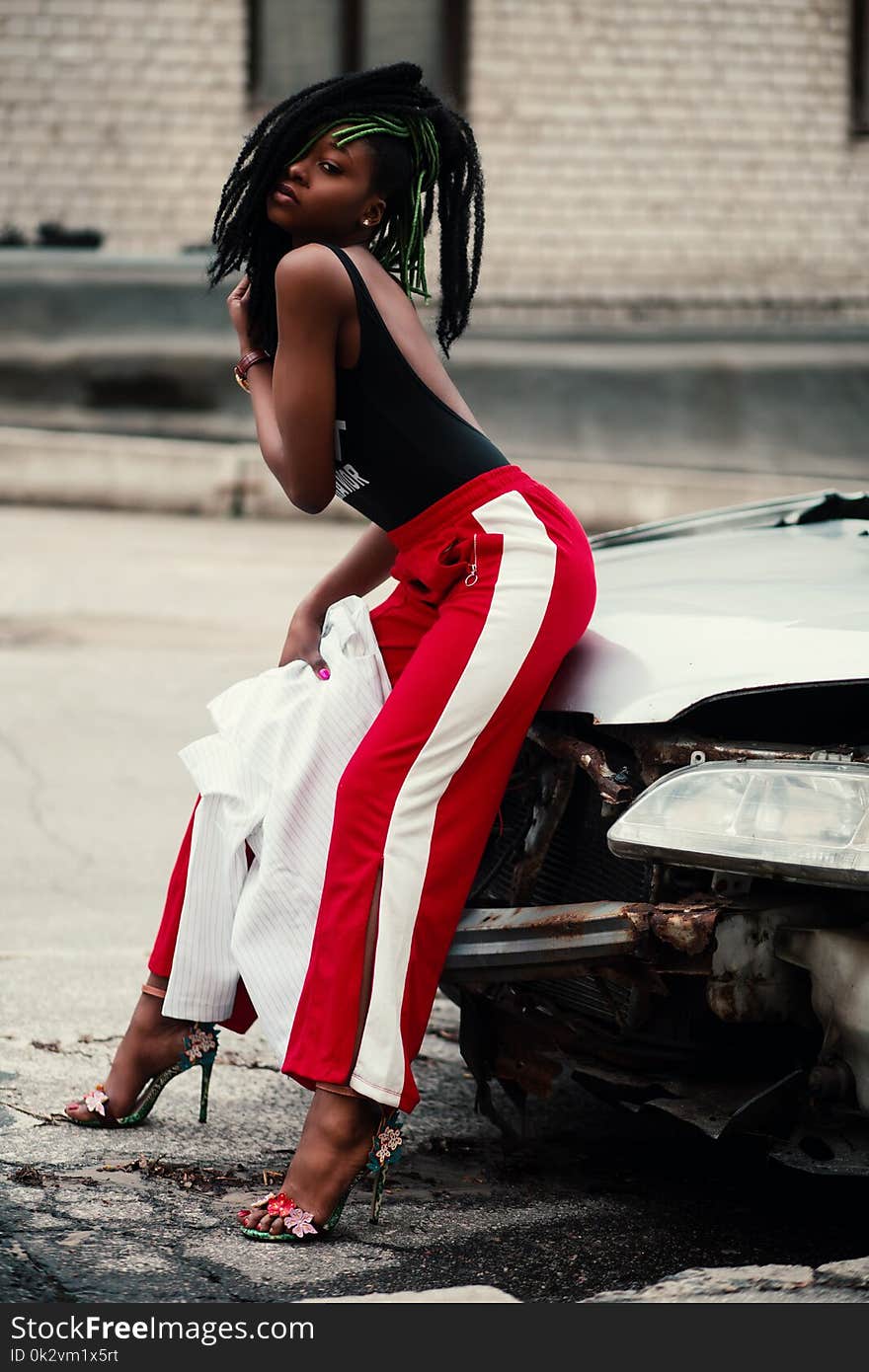 Women&#x27;s Wearing Black Backless Top With Red and White Pants